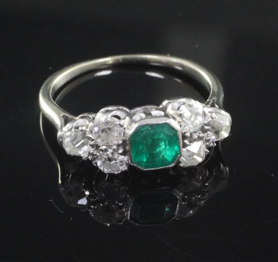 A mid 20th century white gold, emerald and diamond dress ring, size N.